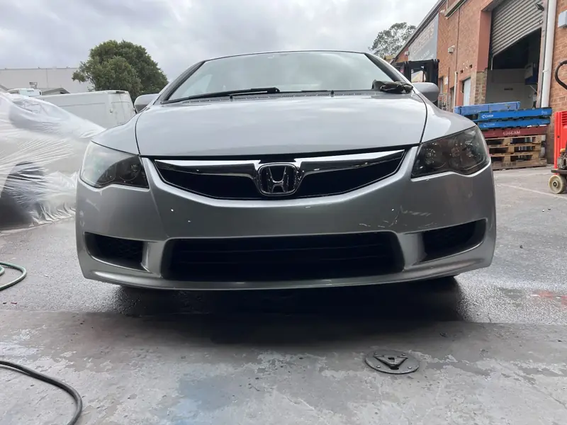 Silver Honda Civic front end in the workshop